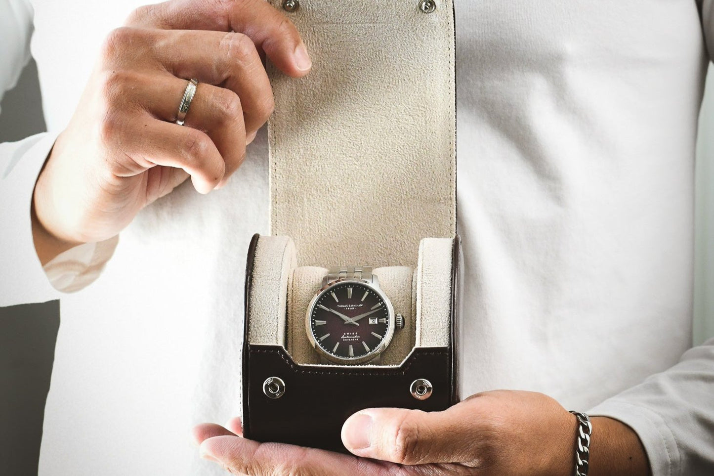 Professional holding the Mirage Luxury Travel Signature Collection Espresso Brown 1-watch roll with an Ivory White premium suede-lined interior, ideal for executive gifting and travel.