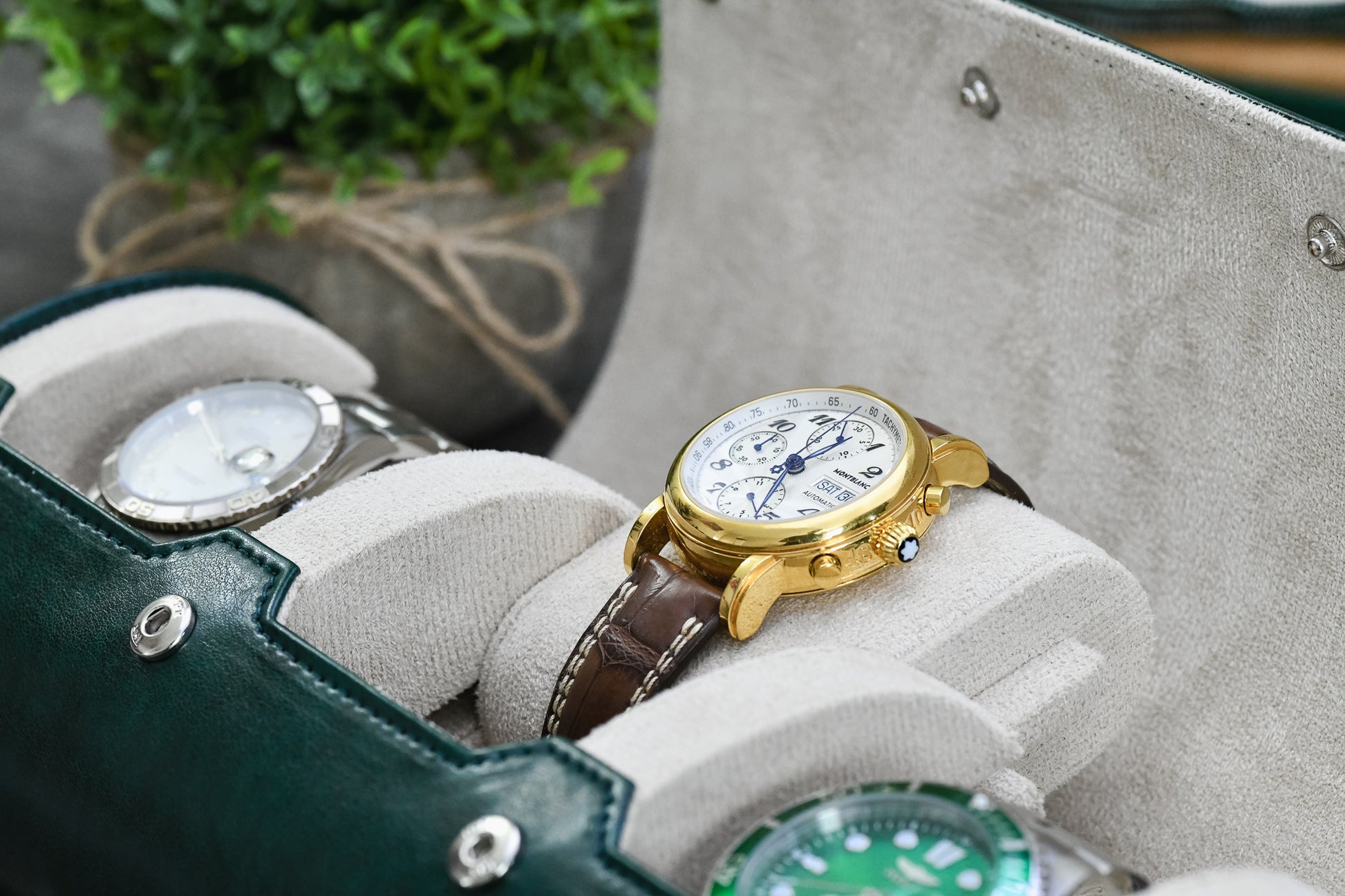 Close-up of luxury watches secured inside Royal Green 3 watch organizer with ivory white suede watch cushions