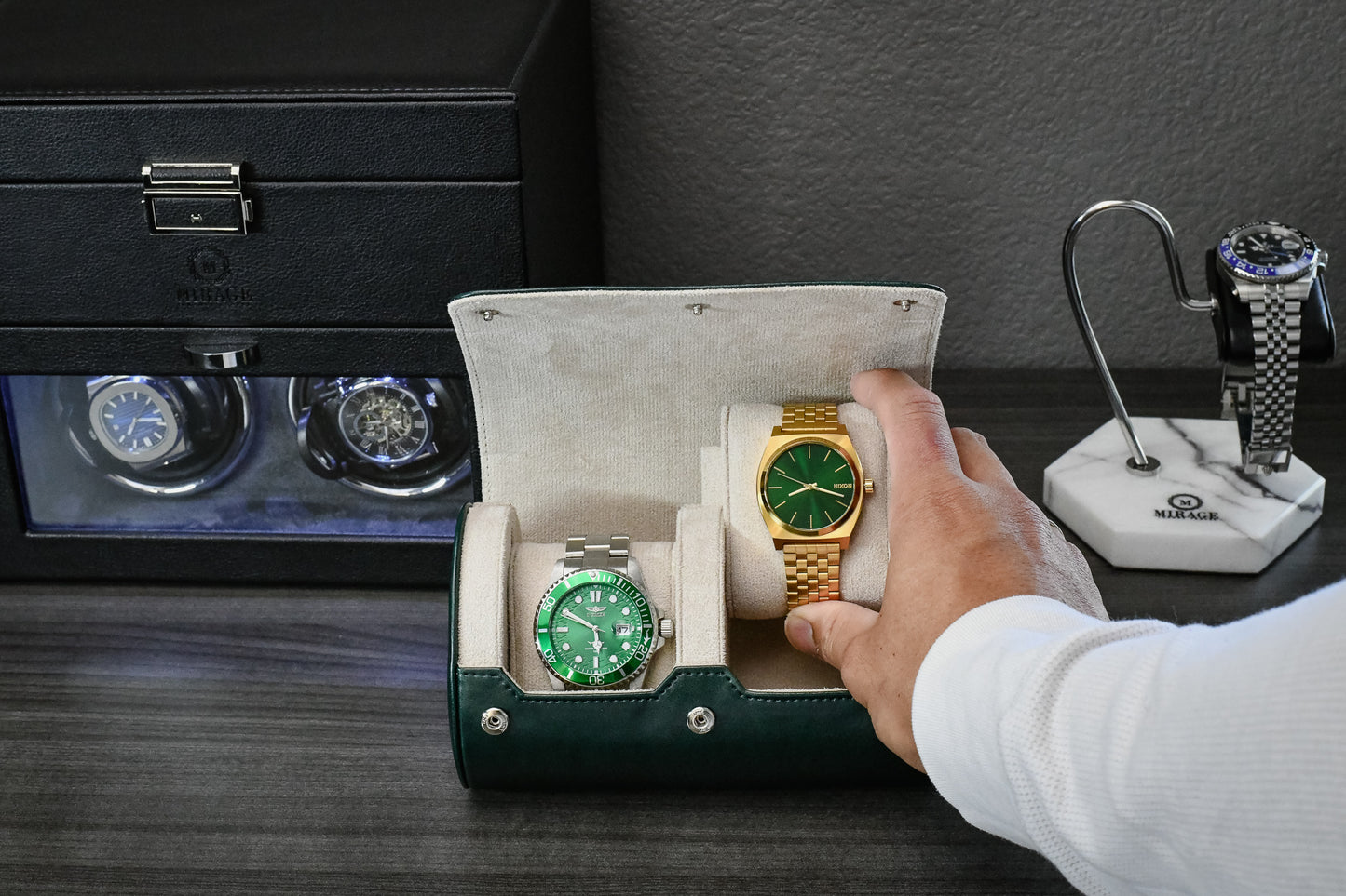 Collector placing a luxury watch into the Royal Green premium vegan leather 2 watch roll with premium suede-lined interior.