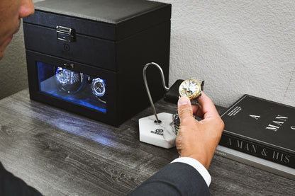 Collector placing a luxury watch onto the Mirage White Lilac Marble watch stand, showcasing premium craftsmanship and elegant everyday display.