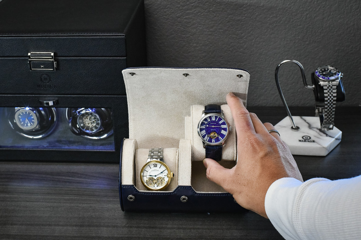 Watch collector placing a luxury timepiece into the Midnight Blue vegan leather 2 watch organizer.
