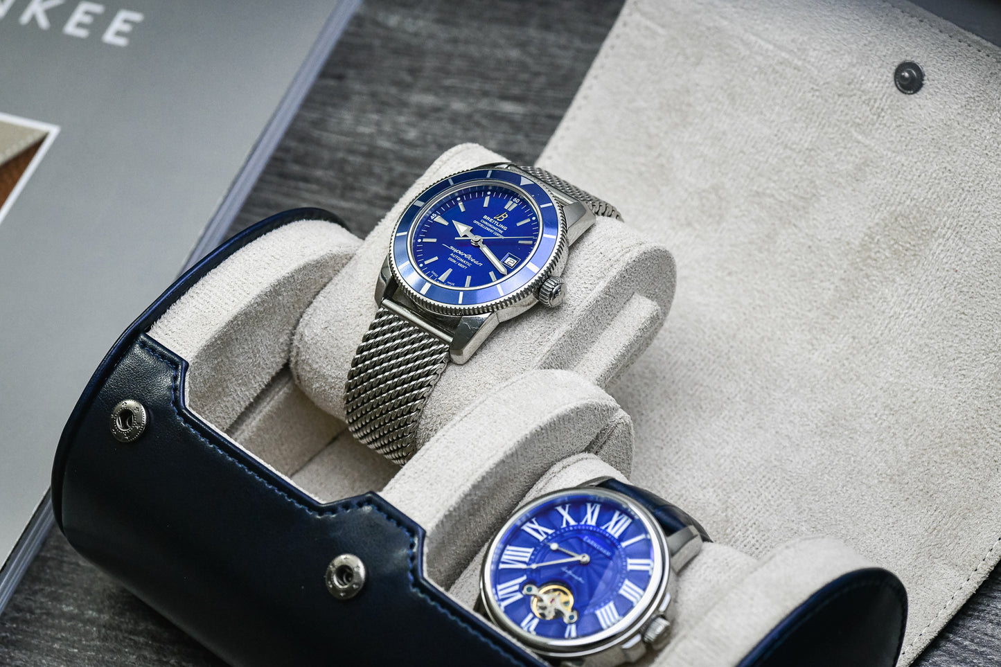 Close-up of luxury watch resting inside the Midnight Blue vegan leather 2 watch travel case with soft ivory white interior.