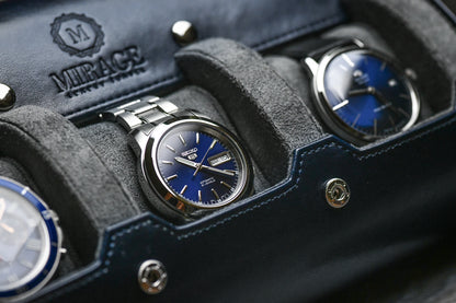 Detailed view of luxury watch resting on premium gray suede sliding cushion inside Midnight Blue watch roll