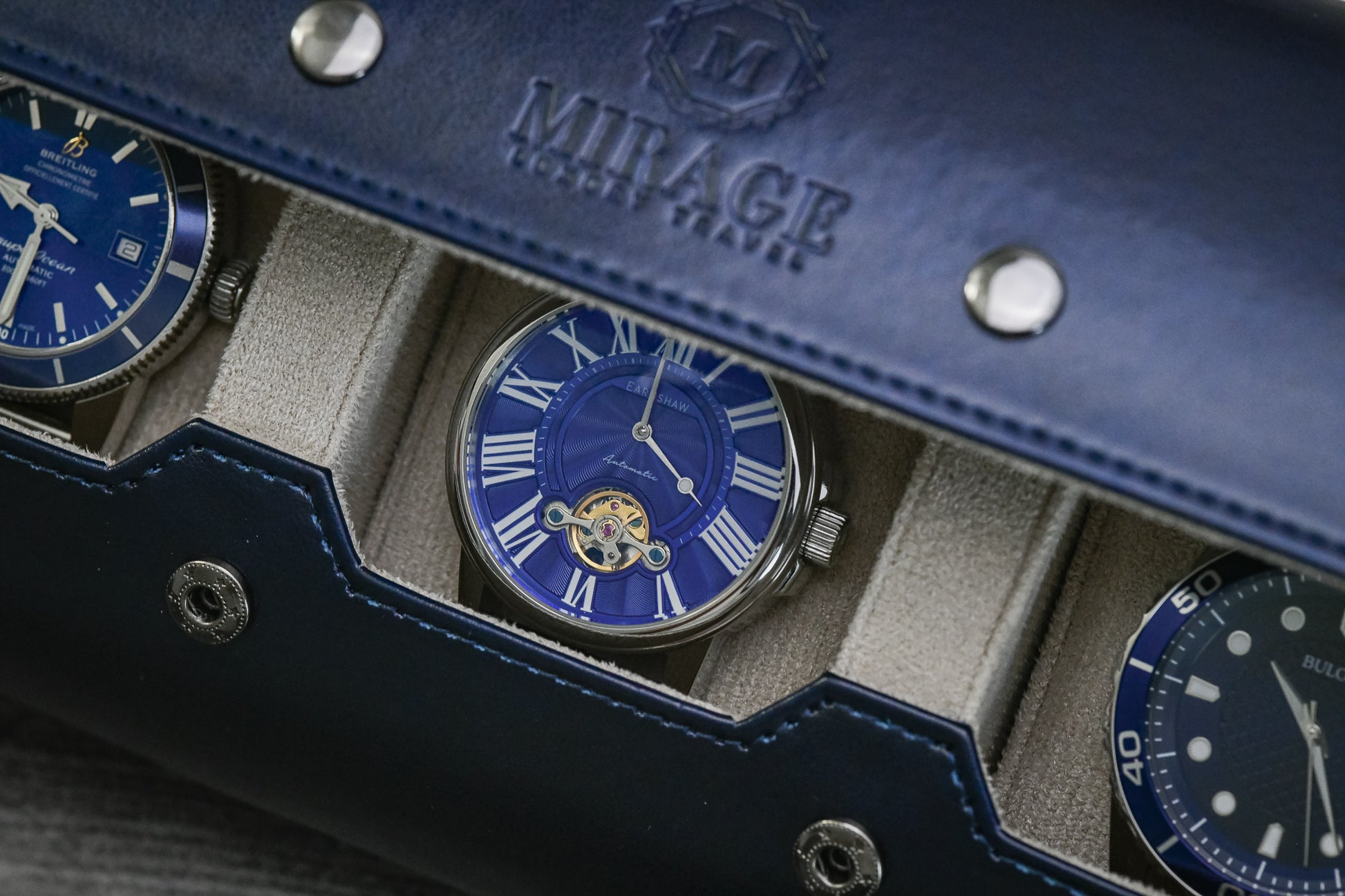 Detailed view of luxury watch resting inside Midnight Blue premium vegan leather watch roll with ivory white lining