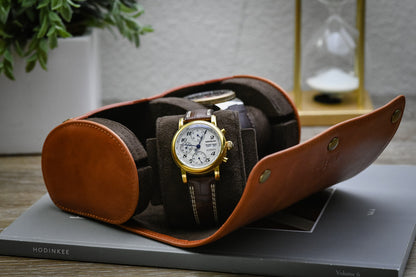 Open Tawny Brown full-grain leather watch roll with two luxury watches secured on plush suede cushions.