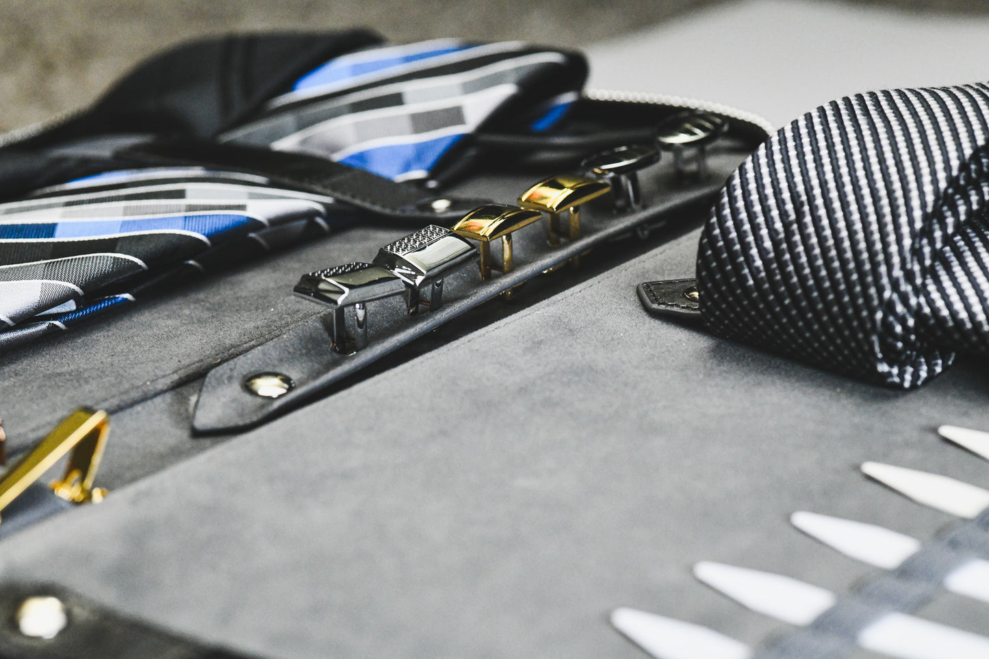 Interior of the Graphite Black premium vegan leather tie travel case displaying organized ties, cufflinks, and travel accessories.