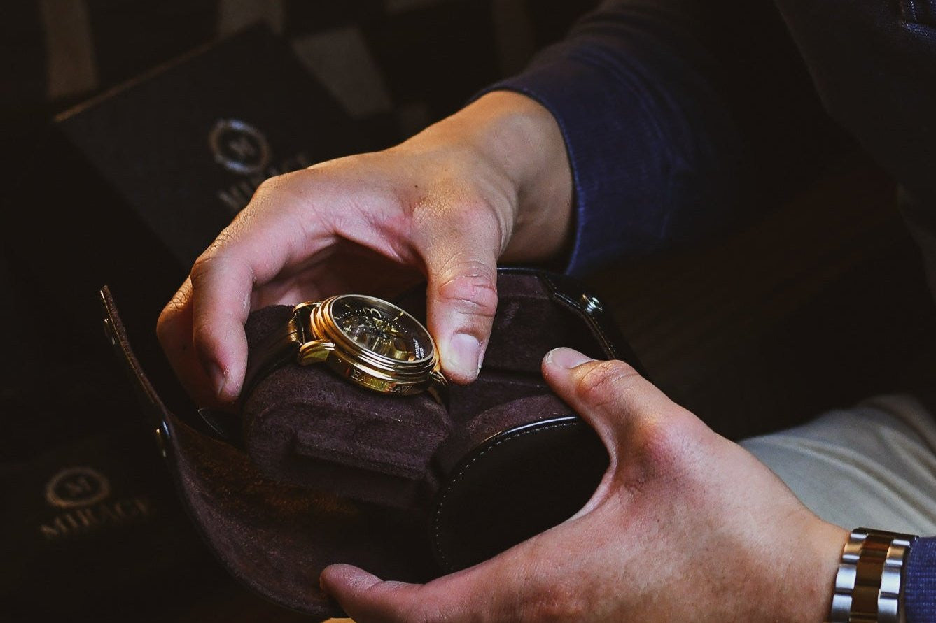 Collector opening the Mirage Luxury Travel Signature Collection Jade Black premium vegan leather 1-watch roll, revealing the premium suede-lined interior and secure sliding watch cushion.