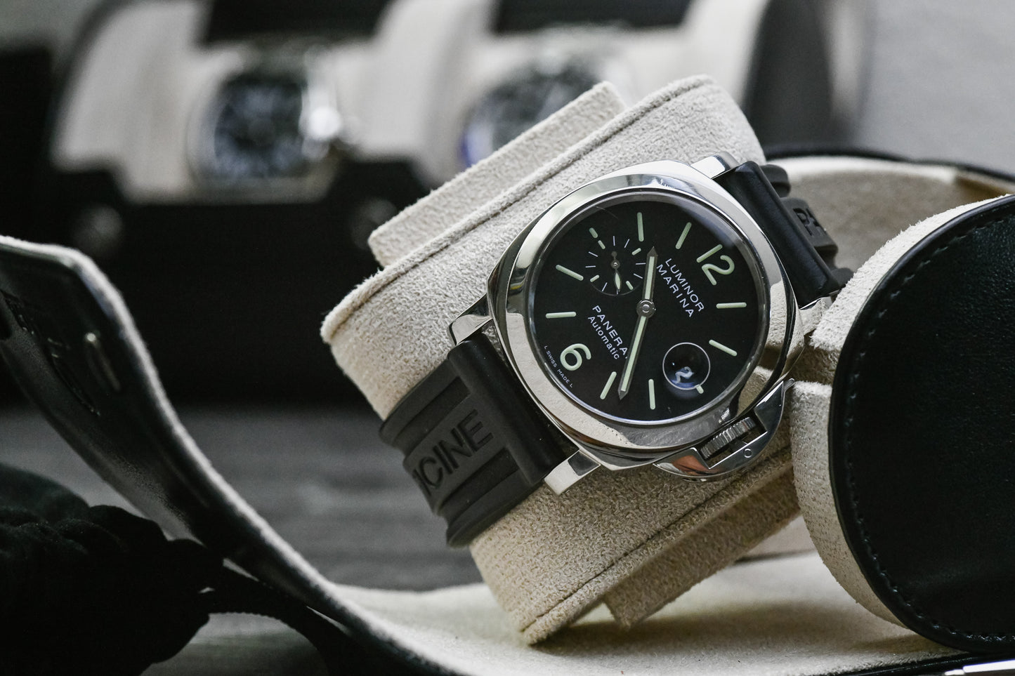 Close-up of a luxury watch secured inside the Mirage Luxury Travel Jade Black vegan leather 1 watch roll with a soft Ivory White suede lining and signature sliding cushion.