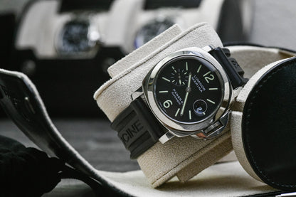 Close-up of a luxury watch secured inside the Mirage Luxury Travel Jade Black vegan leather 1 watch roll with a soft Ivory White suede lining and signature sliding cushion.