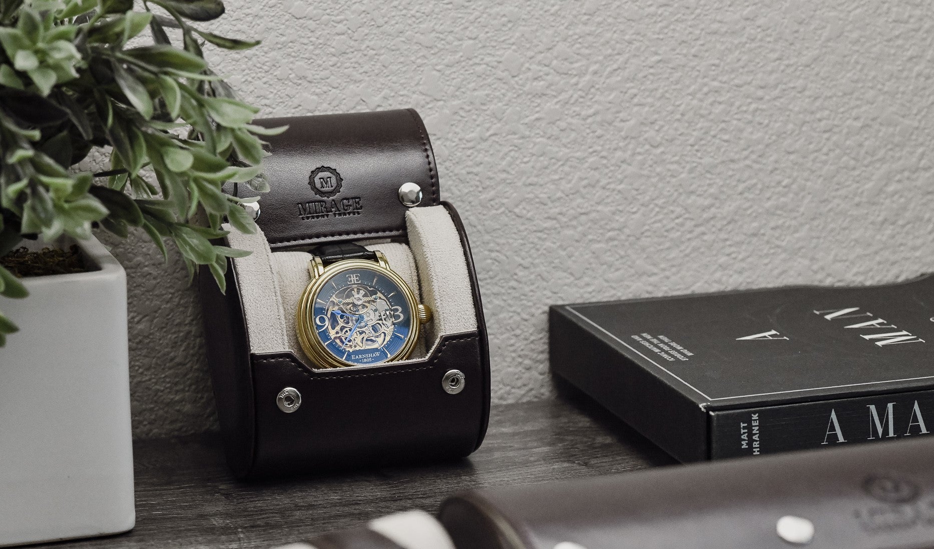 Mirage Luxury Travel Signature Collection Espresso Brown luxury watch roll with an Ivory White premium suede-lined interior displayed in a modern office setting for everyday watch storage.