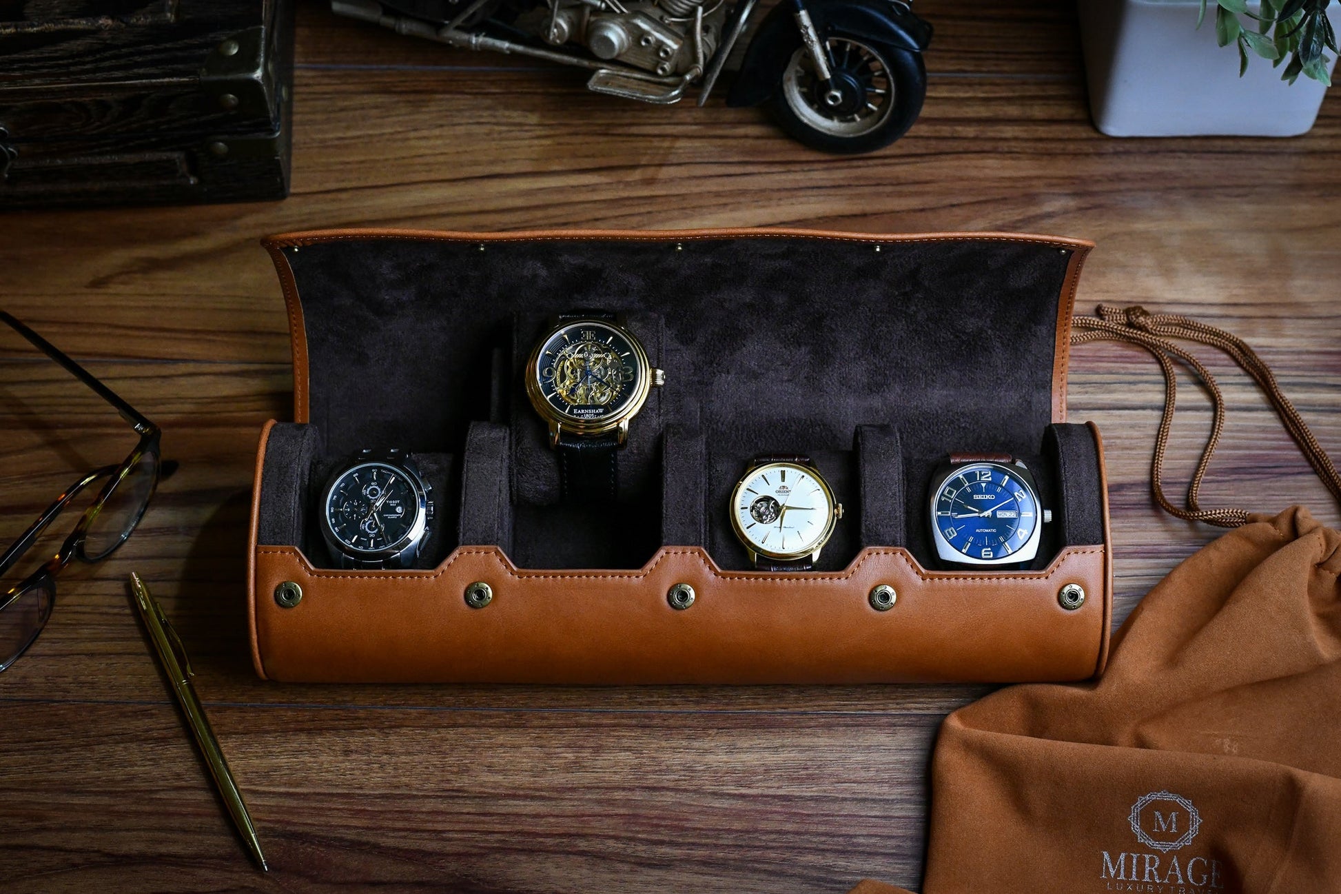 Luxury watch organizer displaying four watches inside a premium leather travel case.