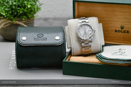 Royal Green vegan leather watch roll displayed with Mirage Luxury Travel gift box and luxury watch.
