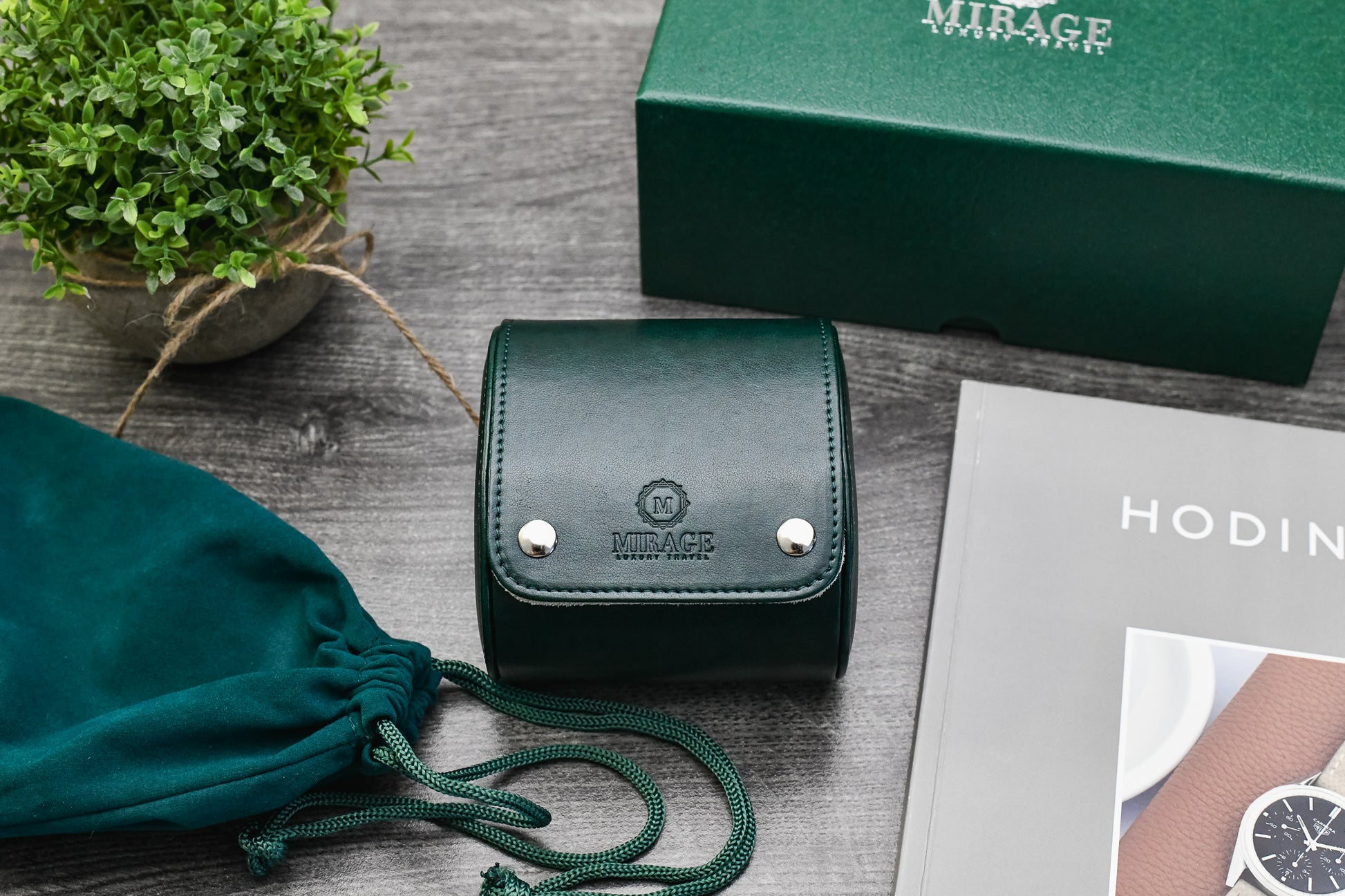 Royal Green vegan leather watch roll displayed with Mirage Luxury Travel gift box and luxury watch.