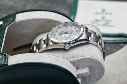 Close-up of a luxury watch resting inside the Royal Green vegan leather watch roll with ivory white suede interior.