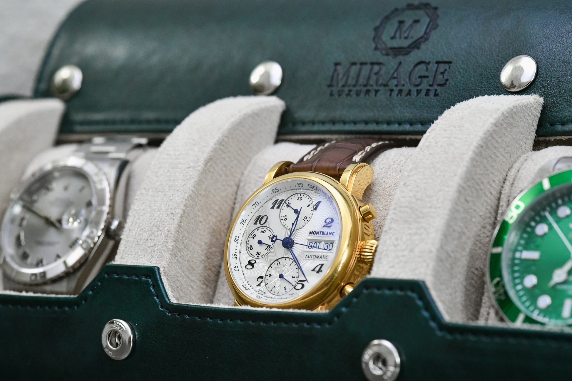 Detailed view of luxury watches resting inside Royal Green premium vegan leather watch roll with ivory white lining