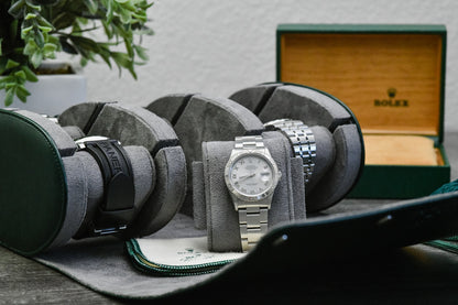 Royal Green luxury watch roll travel case beside camera gear for collectors, business travel, and everyday watch storage