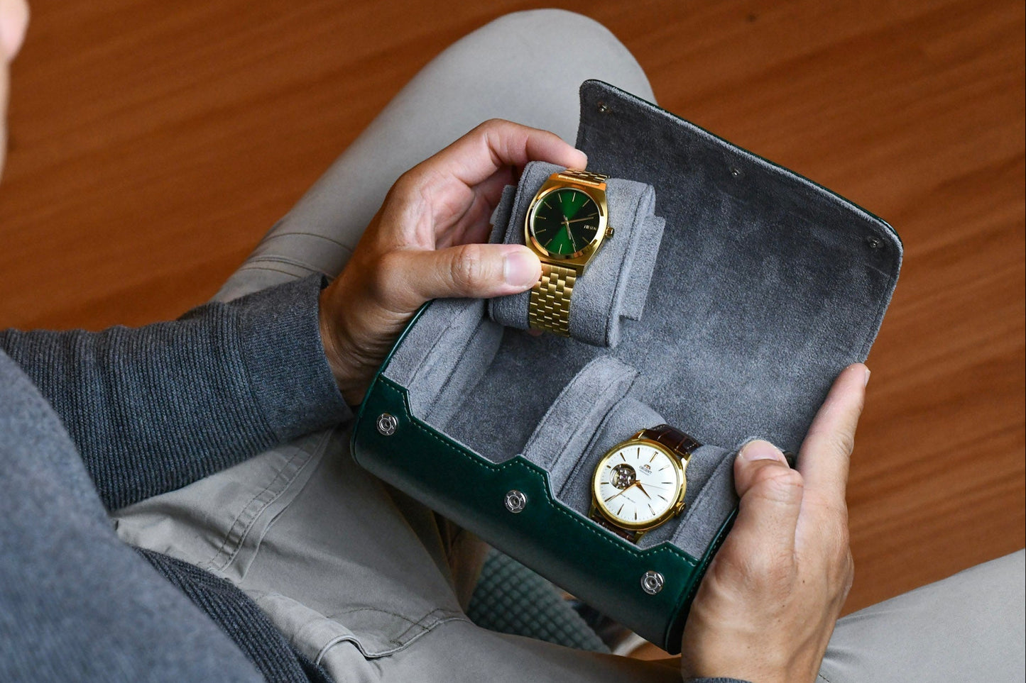Watch collector placing luxury watches inside the Royal Green vegan leather 2 watch travel case.
