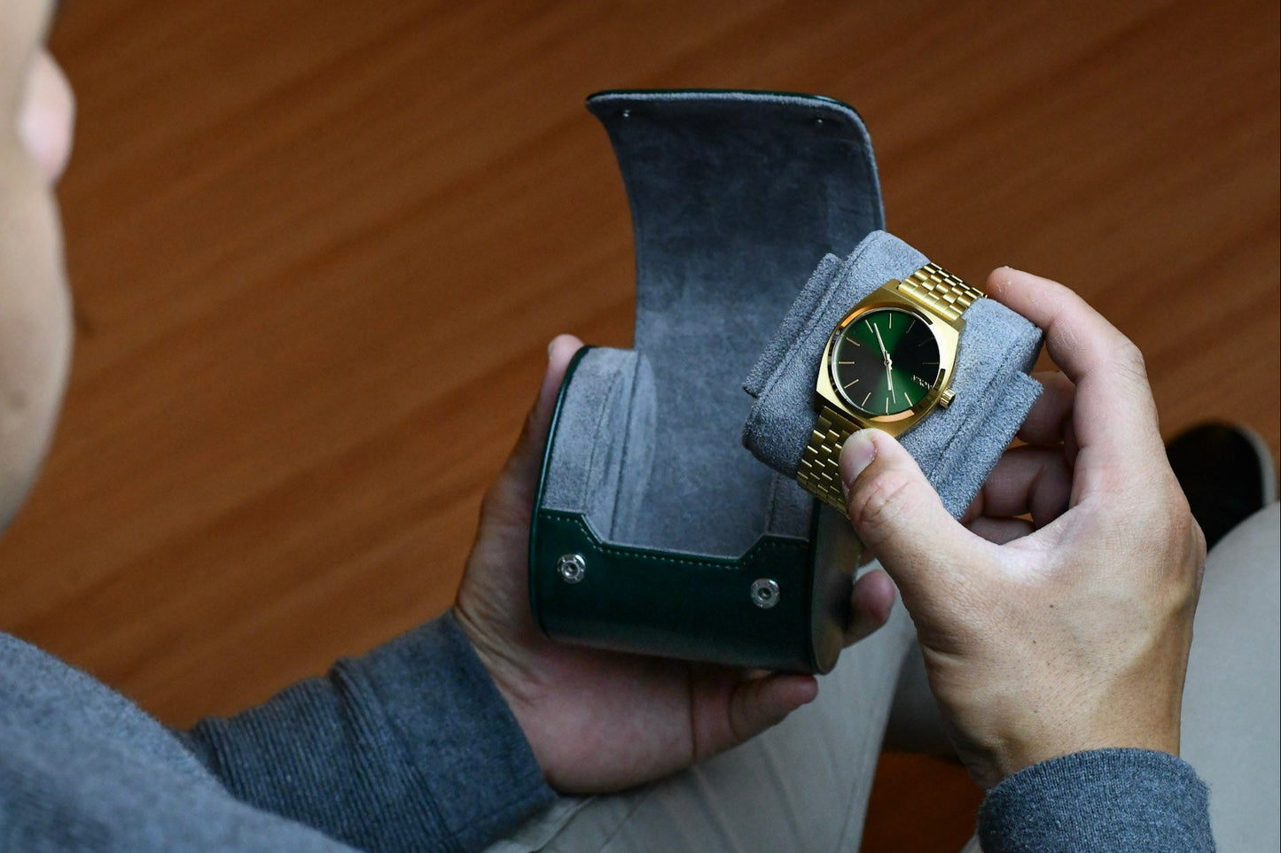 Collector placing a luxury watch into the Royal Green vegan leather travel watch case.