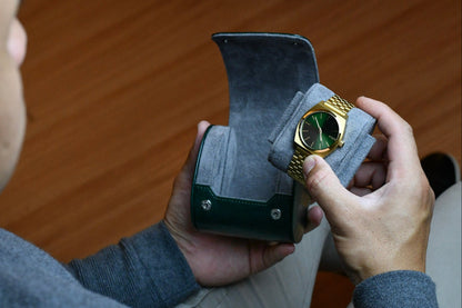 Collector placing a luxury watch into the Royal Green vegan leather travel watch case.