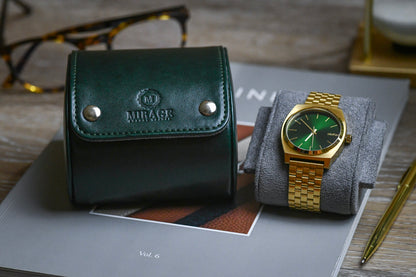 Royal Green vegan leather watch roll displayed with a luxury timepiece and Mirage Luxury Travel packaging.