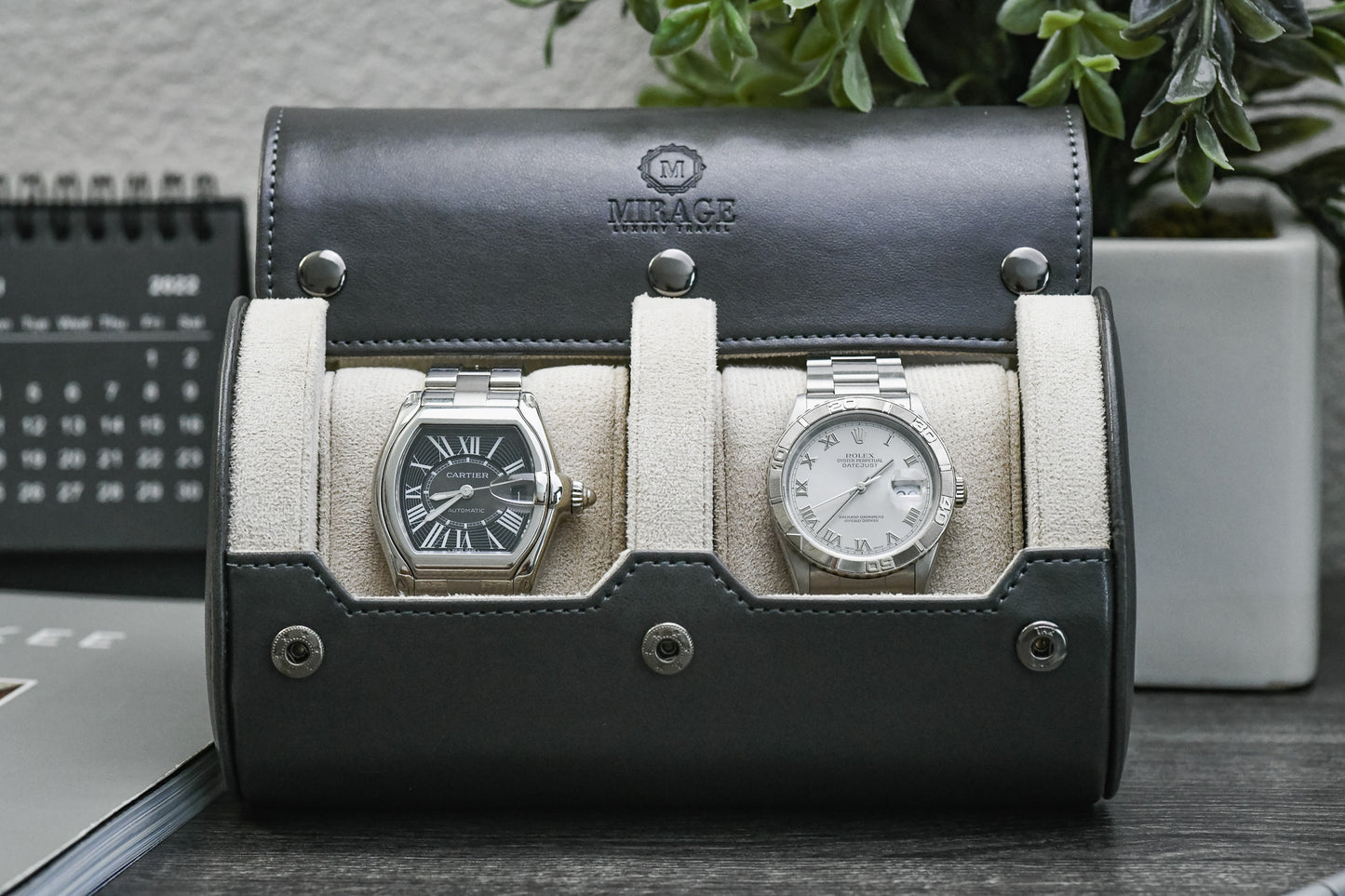Slate Gray vegan leather 2 watch travel case displayed with luxury watches in a premium collector workspace.
