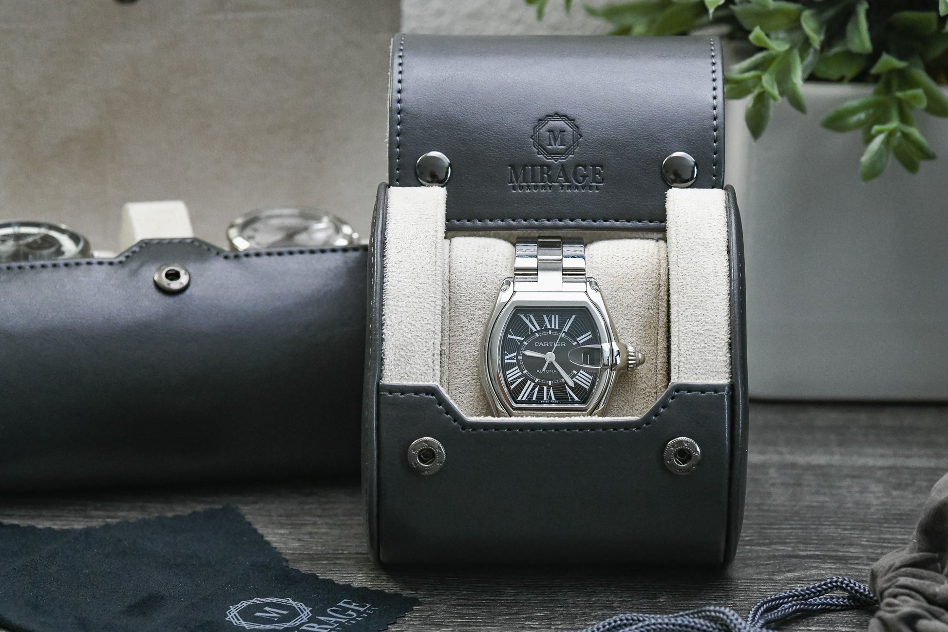 Front view of the Slate Gray vegan leather 1 watch roll showcasing its ivory white suede interior and secure watch cushion.