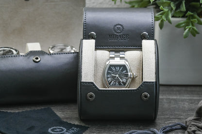 Front view of the Slate Gray vegan leather 1 watch roll showcasing its ivory white suede interior and secure watch cushion.