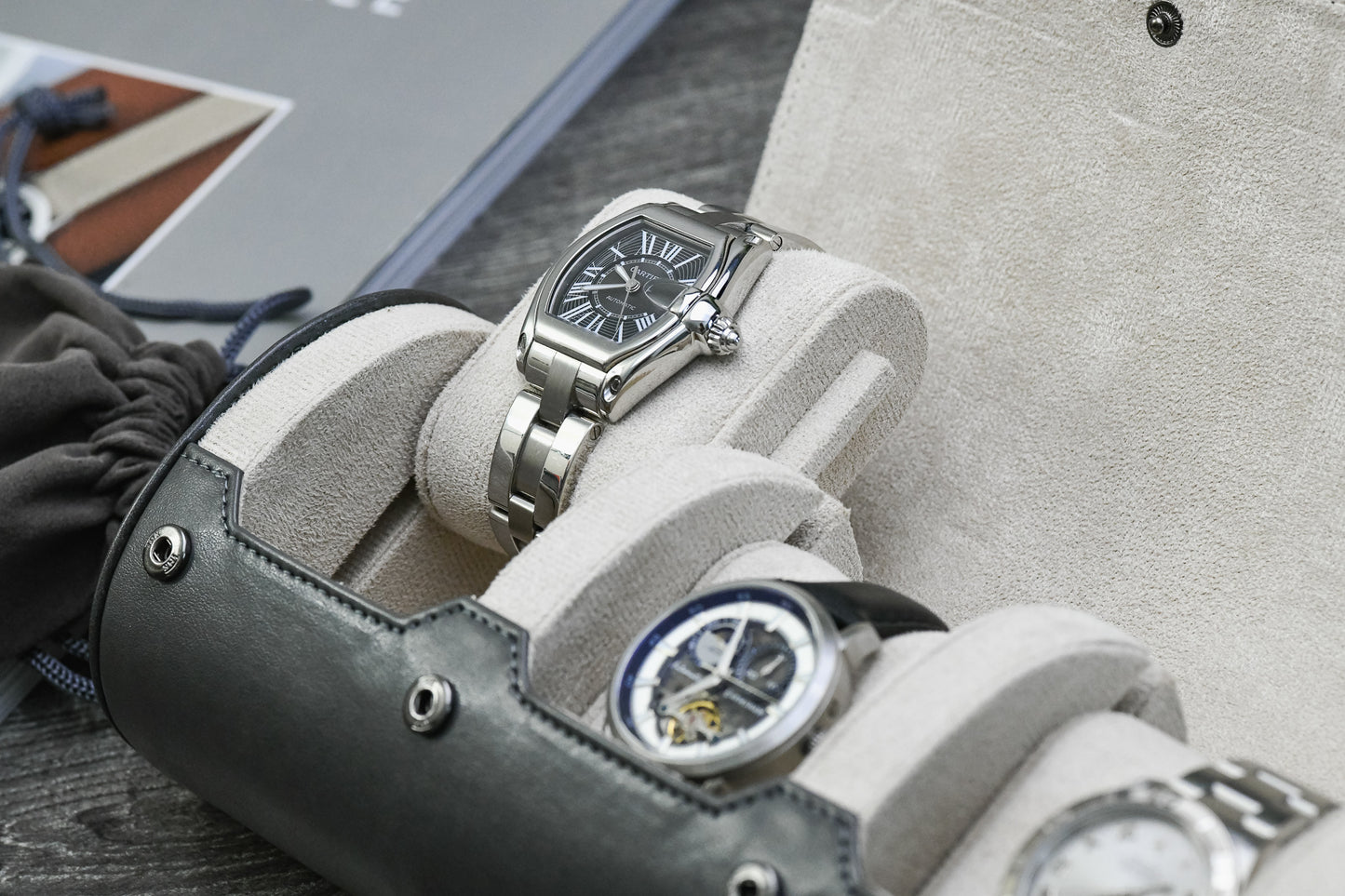 Close-up of luxury watches secured inside Slate Gray 3 watch travel case with ivory white suede watch cushions