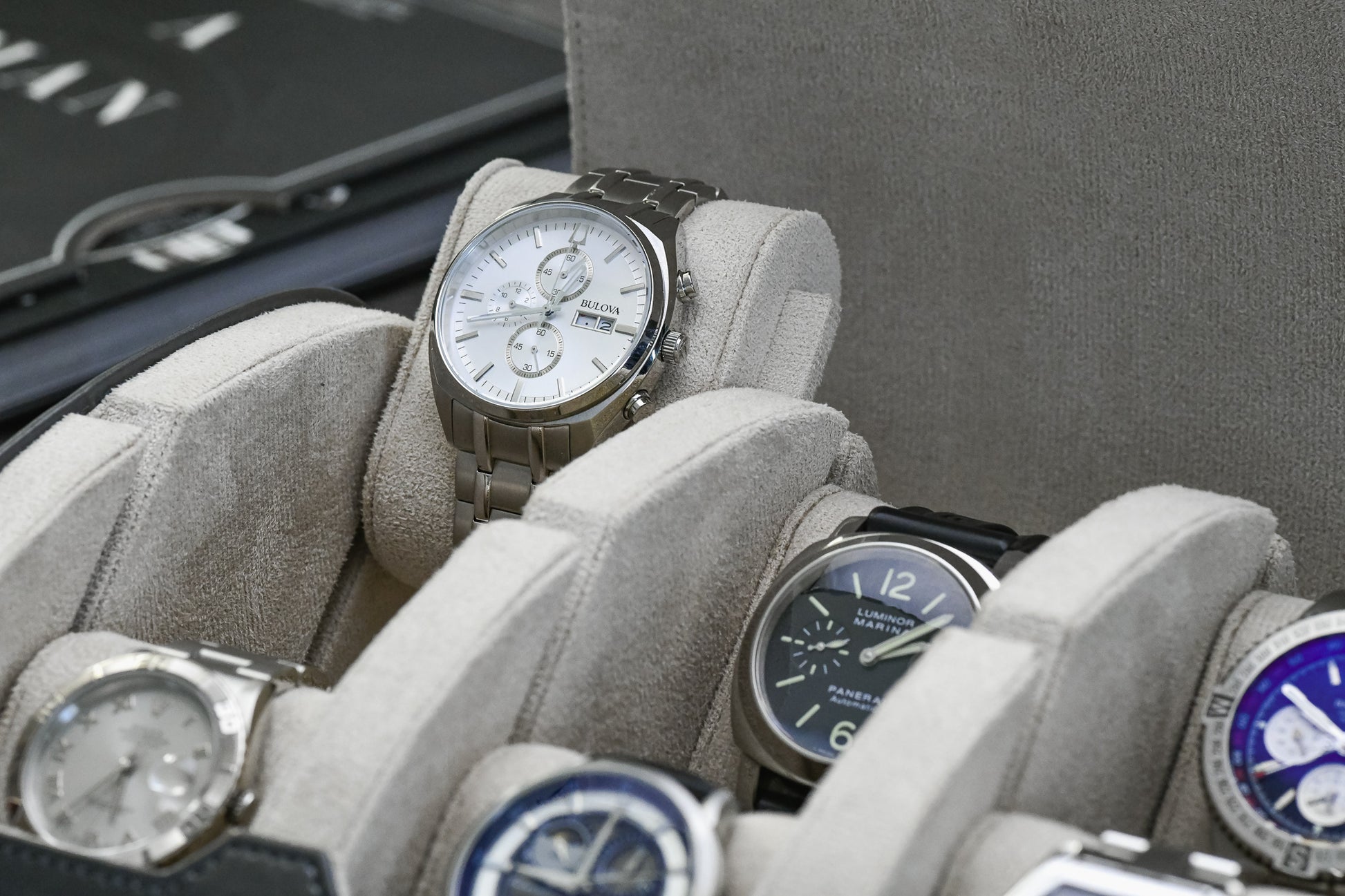 Close-up of luxury watch protected inside Slate Gray premium vegan leather watch roll with ivory white suede lining