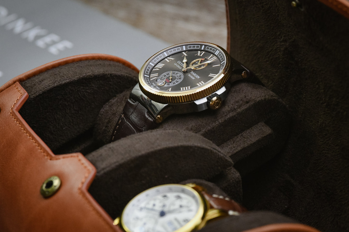 Close-up of luxury watches resting on Mirage signature sliding cushions inside a Tawny Brown leather watch roll.