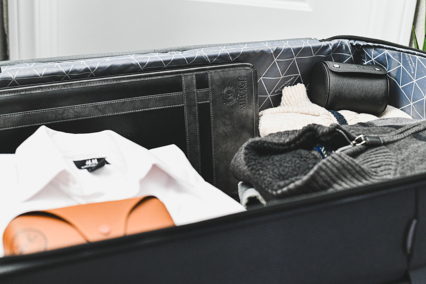 Graphite Black premium vegan leather tie travel case packed inside a suitcase, showcasing compact travel organization for formal accessories.