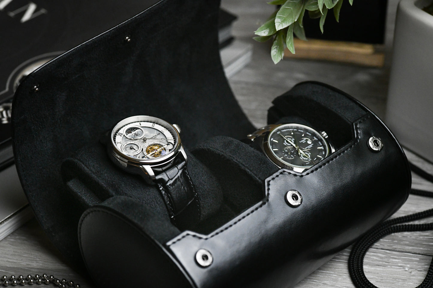 Luxury watches stored inside the Super Black vegan leather 2 watch organizer with plush suede interior.