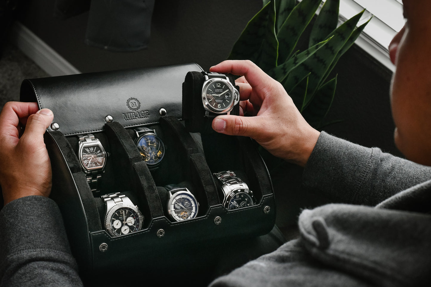 Watch collector organizing luxury watches inside the Super Black premium vegan leather 6 watch travel case