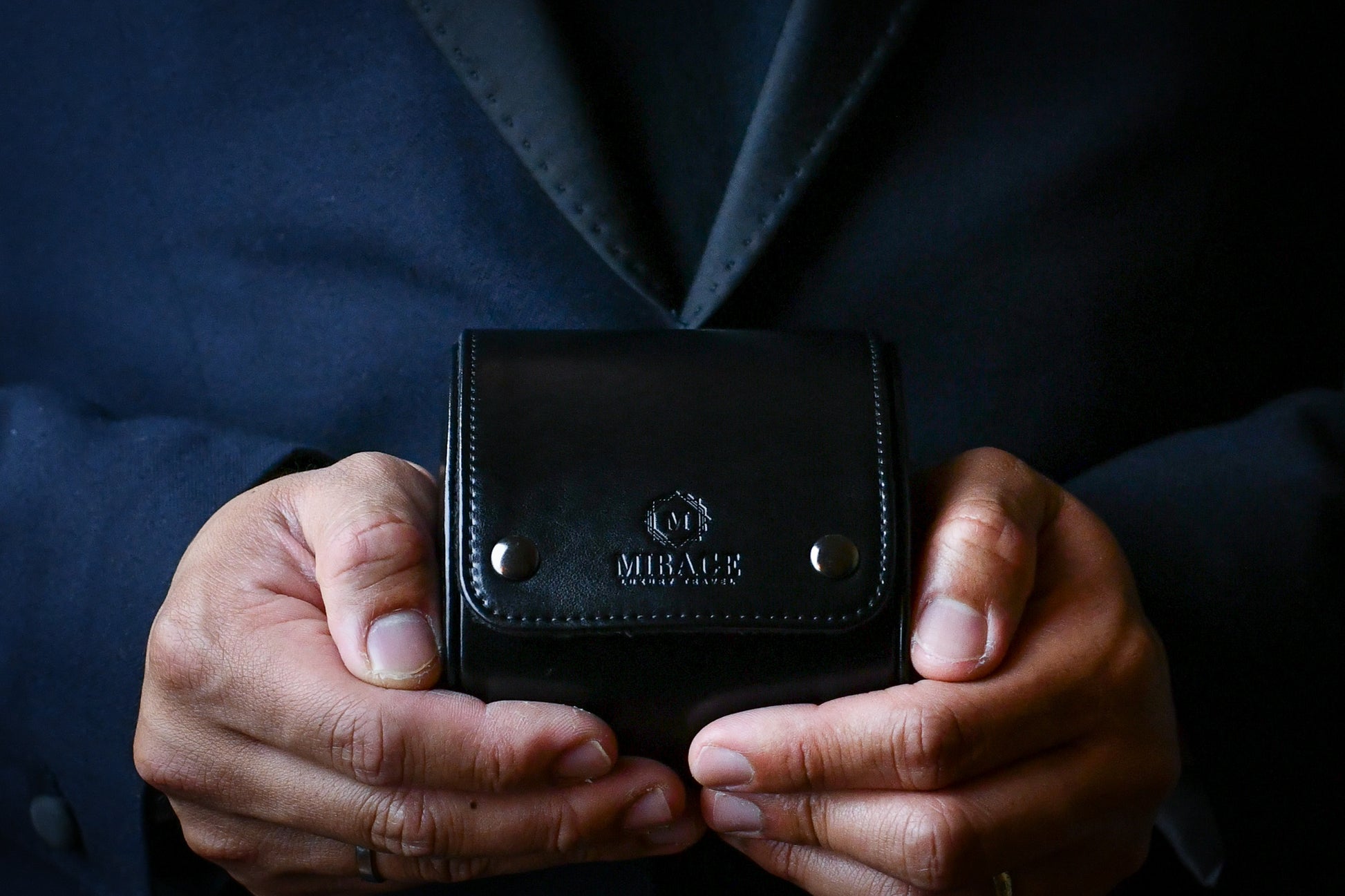 Collector holding the Super Black vegan leather 1 watch roll during everyday travel.