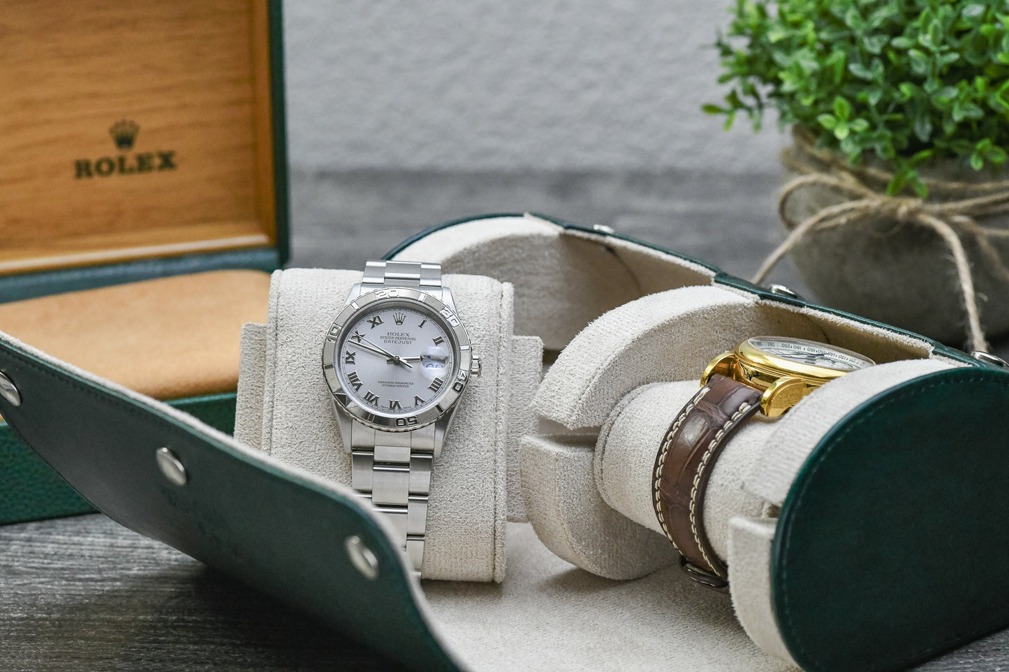 Royal Green premium vegan leather 2 watch roll displayed beside luxury watches, highlighting compact travel-ready protection.