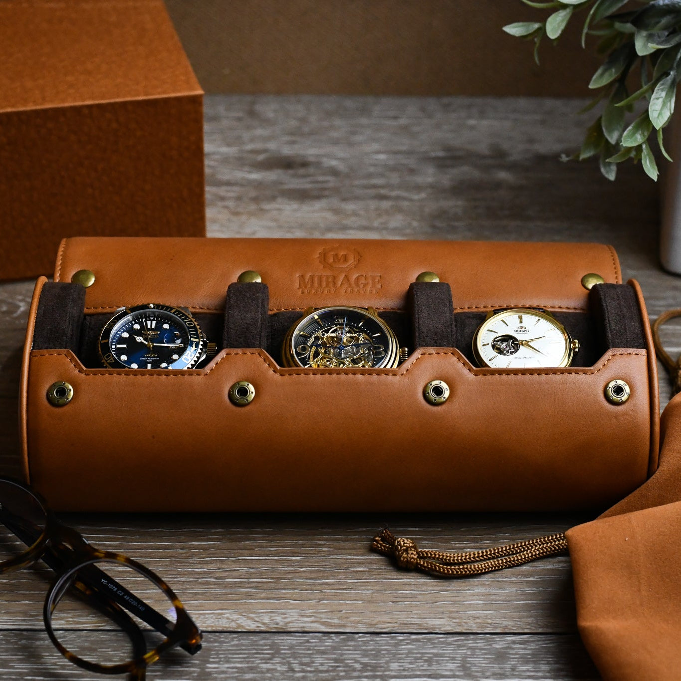 Tawny Brown full-grain leather 3 watch roll displaying luxury watches with premium travel accessories.