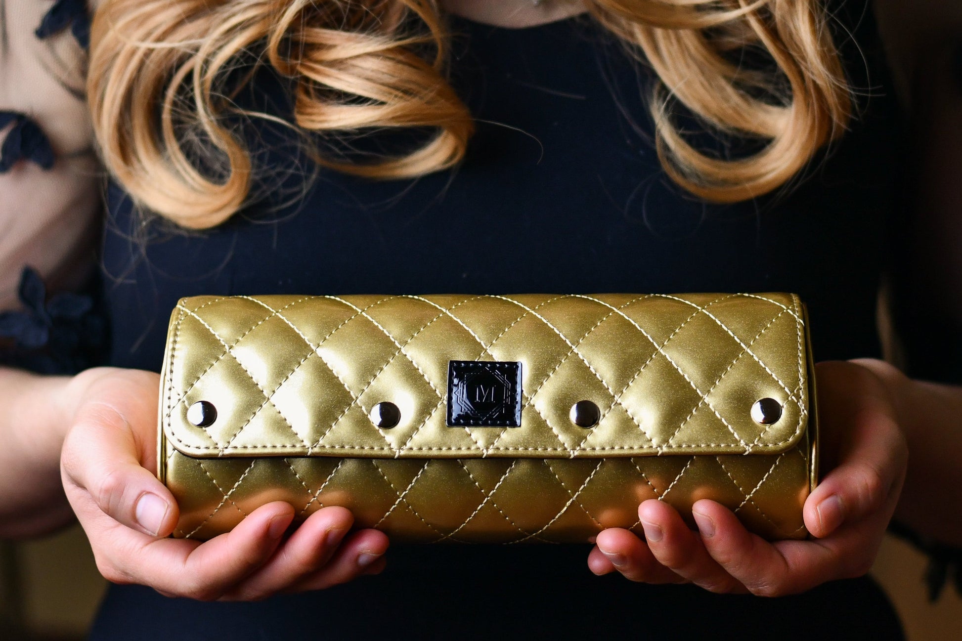 Woman holding a Royal Gold premium vegan leather 3 watch roll featuring diamond quilting, luxury watch travel case and elegant gift for women's Rolex, Cartier, Omega, and luxury watch collections