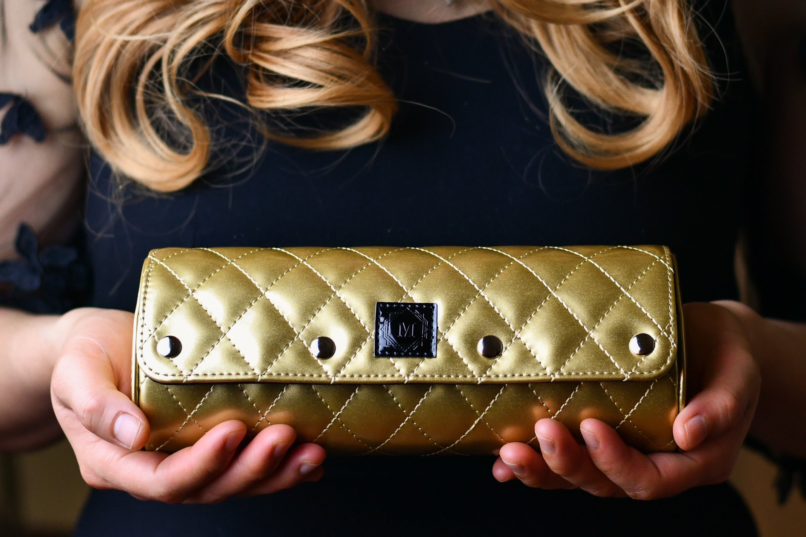 Woman holding a Royal Gold premium vegan leather 3 watch roll featuring diamond quilting, luxury watch travel case and elegant gift for women's Rolex, Cartier, Omega, and luxury watch collections