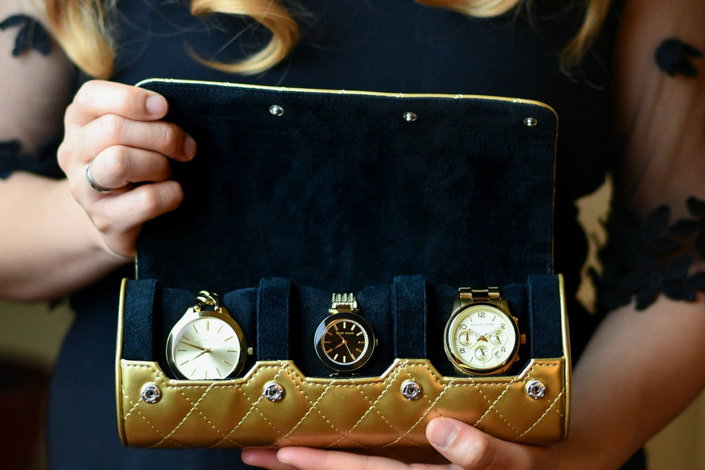 Woman holding a Royal Gold luxury 3 watch roll travel case designed for women's Rolex, Cartier, Omega, and luxury watch collections