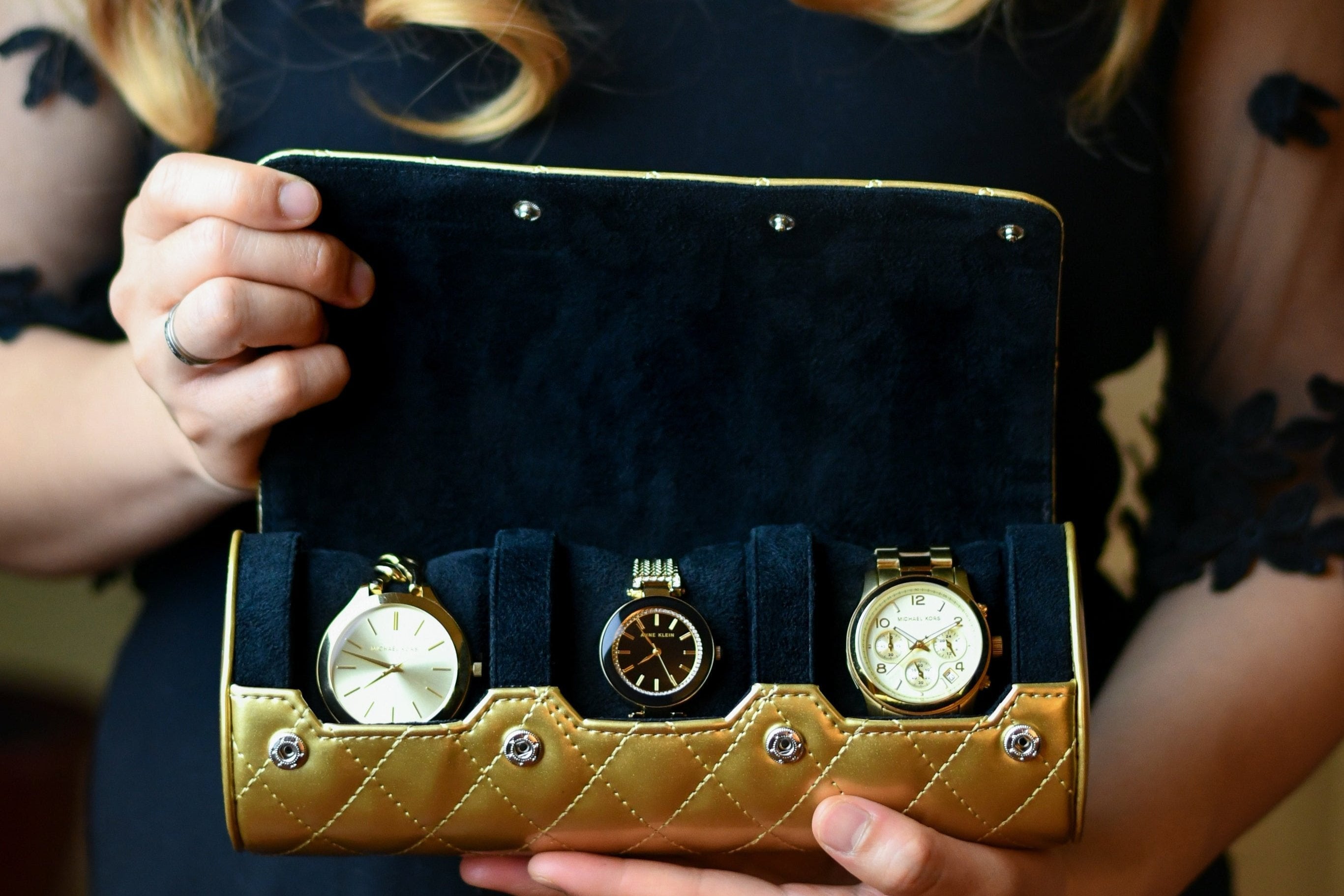 Woman holding a Royal Gold luxury 3 watch roll travel case designed for women's Rolex, Cartier, Omega, and luxury watch collections