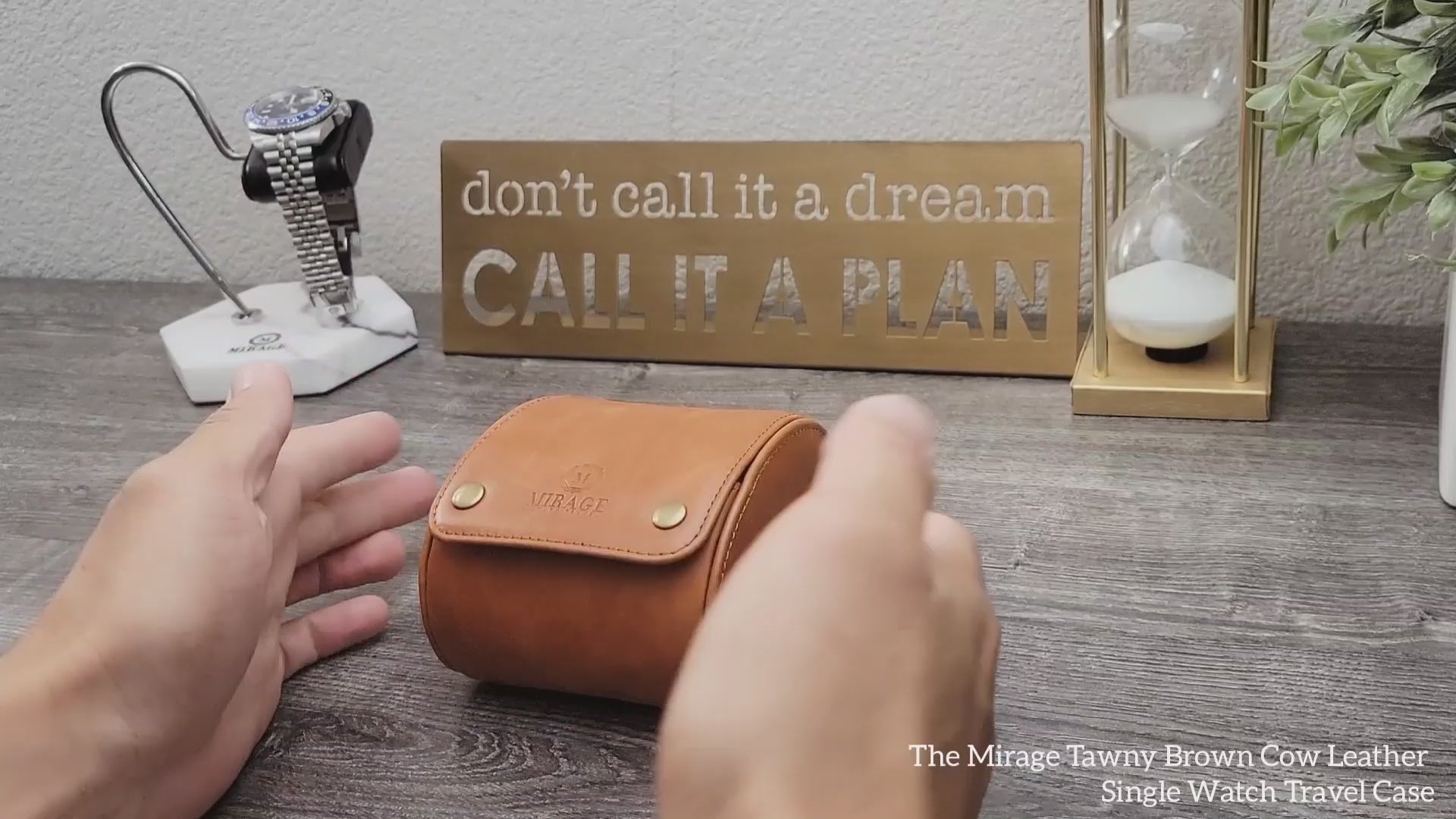 Hands opening the Mirage Luxury Travel Tawny Brown leather 1 watch roll, highlighting the premium unboxing experience.